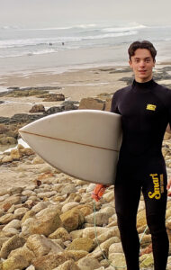 Ludovico holding a surfboard