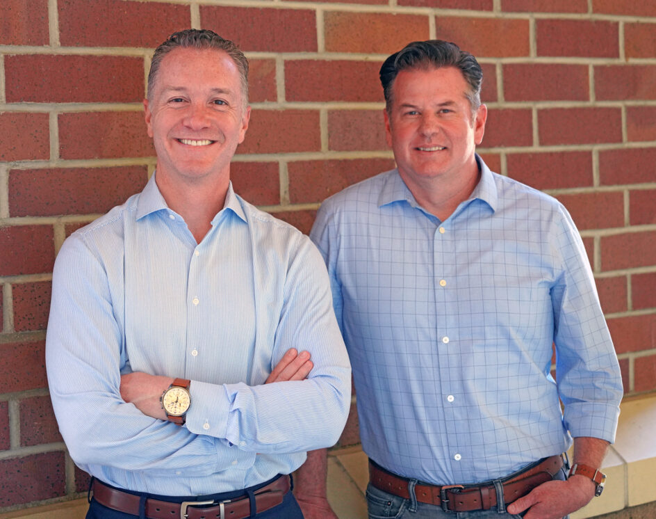 Joshua Grill and Daniel Gillen in front of brick background