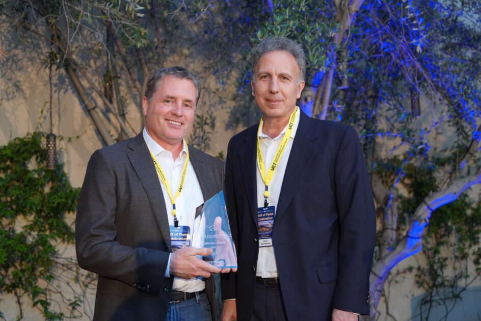 Fritz Onion standing with ICS Dean Marios Papaefthymiou and holding his Hall of Fame award.