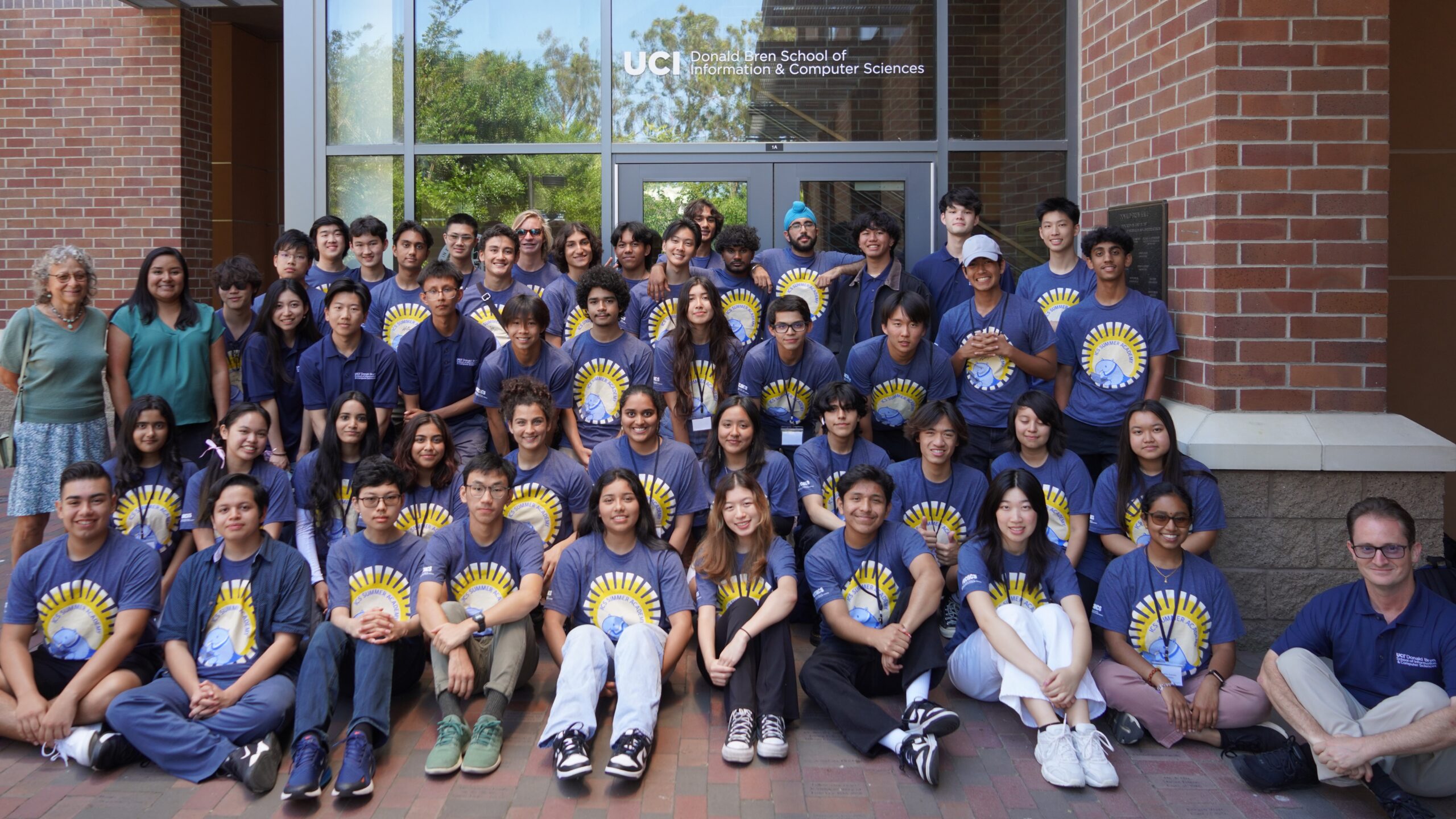 A large group of students outside Donald Bren Hall at UCI.