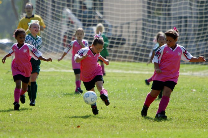 Walden, Natalie, and Vanessa bring the ball upfield