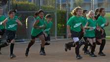 The Hot Shots run out to the mound for the post-game cheers