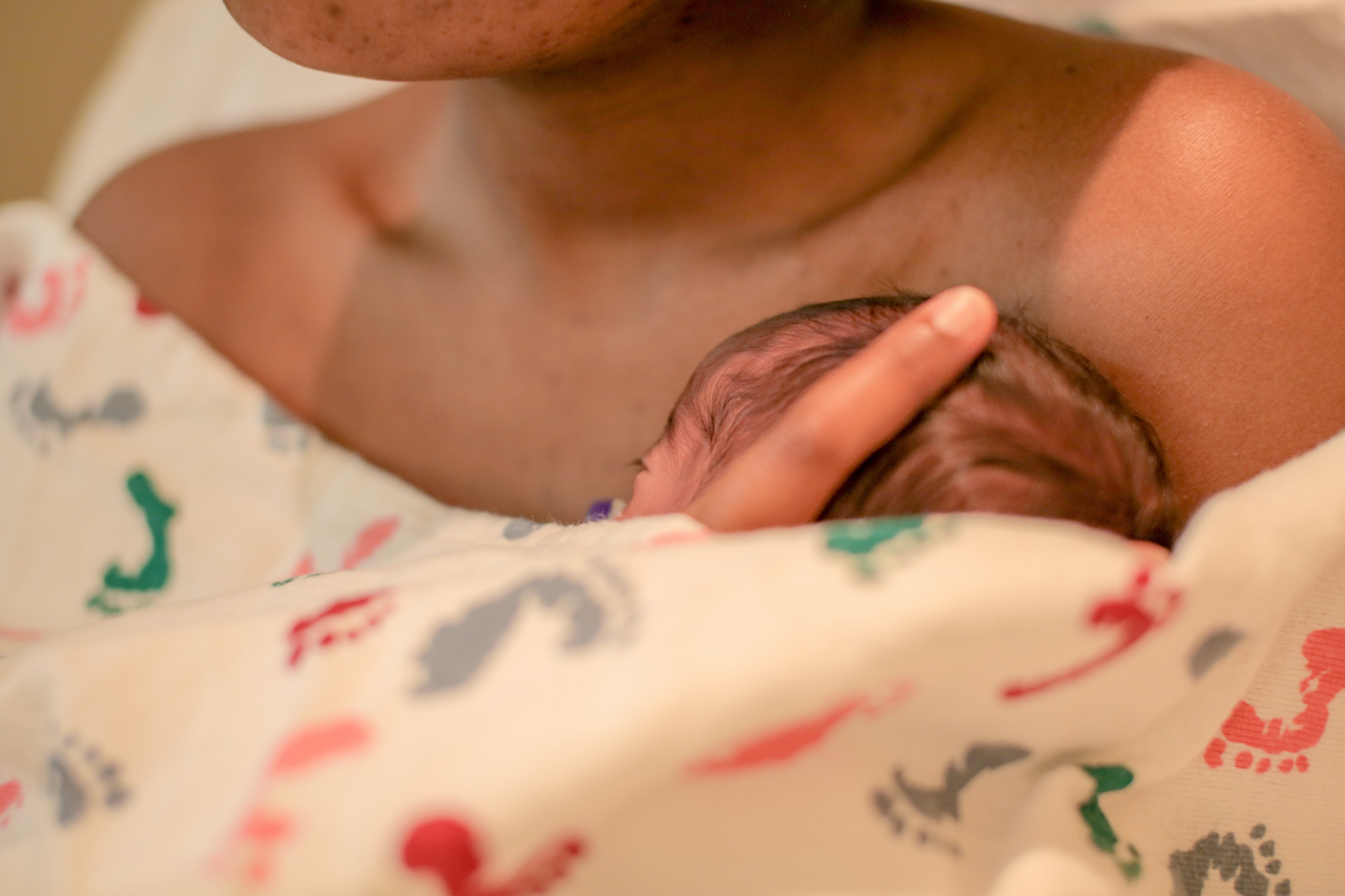 a baby sleeping on a woman's chest